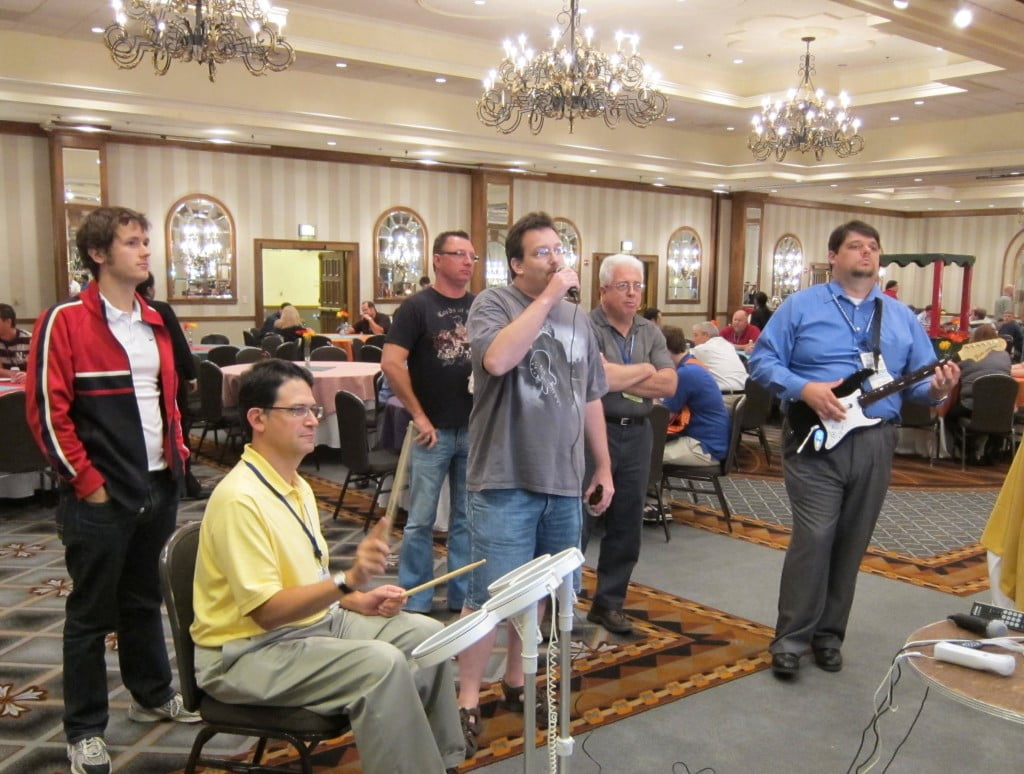 Drums, Alan Seiden; vocals, Rich Nemerovsky; guitar, Brian May, playing the "Rock Band" Wii game at Fall COMMON conference, San Antonio, Texas, October 5, 2010